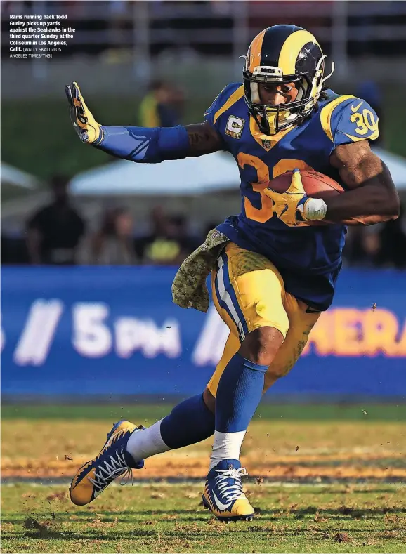  ?? [WALLY SKALIJ/LOS ANGELES TIMES/TNS] ?? Rams running back Todd Gurley picks up yards against the Seahawks in the third quarter Sunday at the Coliseum in Los Angeles, Calif.