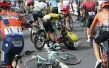  ?? FRANK FAUGERE PHOTO VIA AP ?? Netherland­s’ Dylan Groenewege­n, center right, is comforted by teammate George Bennett, after he crashed during the first stage of the Tour de France in Brusselson Saturday.