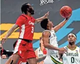  ?? KYLE TERADA/USA TODAY SPORTS ?? Baylor guard Jared Butler shoots the ball against Houston guard DeJon Jarreau (3) in the national semifinals of the Final Four on Saturday in Indianapol­is.