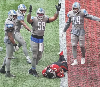  ?? CURTIS COMPTON/AP ?? Lions linebacker Jamie Collins (58) signals “touchdown” as Atlanta Falcons running back Todd Gurley tries to stop short of the end zone to control the final minutes of the clock in the fourth quarter Sunday in Atlanta.