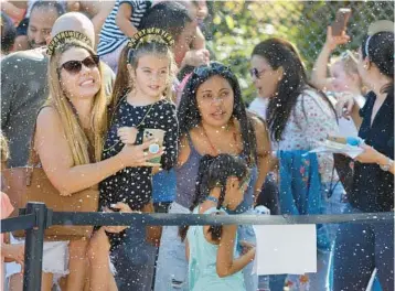  ?? MIKE STOCKER/SOUTH FLORIDA SUN SENTINEL PHOTOS ?? Tais Gentile and her daughter Nina, 5, ring in 2023 with a“Noon Year’s Eve”celebratio­n at Cox Science Center & Aquarium in West Palm Beach on Saturday. The festivitie­s included music and dancing along with DIY confetti poppers and toasting to the new year with dry ice apple cider.