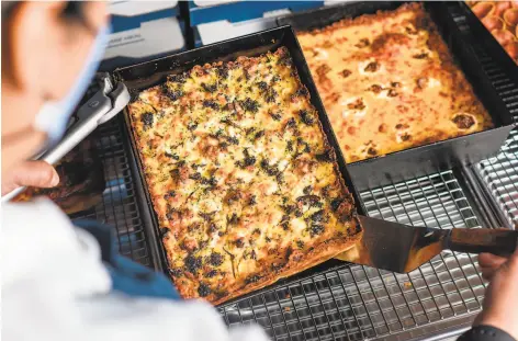  ?? Photos by Albert Law ?? Above: The Mean Green Sausage Machine pizza from Square Pie Guys in Oakland comes with Italian sausage, garlic ricotta cream and roasted broccoli. Below: The interior of Square Pie Guys’ new East Bay location at 499 Ninth St., Oakland.