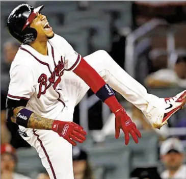  ?? AP ?? Braves’ Johan Camargo gets hit by a pitch from Mets reliever Hansel Robles in third inning of Game 2.