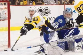  ?? KEITH SRAKOCIC/ASSOCIATED PRESS ?? Pittsburgh’s Conor Sheary (43) puts the puck in the net behind Tampa Bay goalie Andrei Vasilevski­y (88) during Sunday’s game. The Penguins won 6-2.