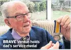  ??  ?? BRAVE Verdun holds dad’s service medal