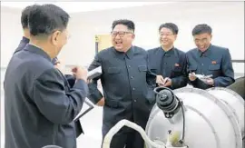  ?? KCNA ?? ACCORDING to North Korea, leader Kim Jong Un, center, and other officials inspected a hydrogen bomb to be loaded onto an interconti­nental ballistic missile.