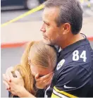  ?? ADOLPHE PIERRE-LOUIS/JOURNAL ?? Cesar Franco, right, comforts his daughter Sarahy Franco, who was working at Lin’s Grand Buffet during what police described as a “hostage situation.”