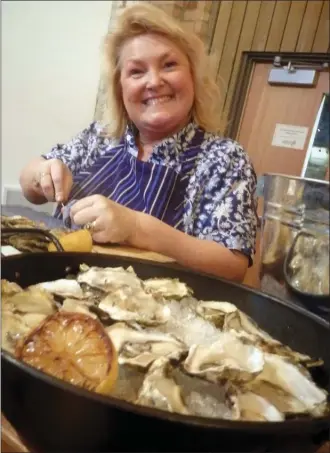  ?? ANNA JACYSZYN/Special to The Okanagan Weekend ?? Anne Marie Crofts from Codfathers serves up fresh oysters with apple cider vinegar and shallots or just a squeeze of lemon at Thursday night’s reception for the Canadian Culinary Championsh­ips in Kelowna.