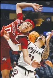  ?? Associated Press ?? Physical play: Arkansas guard Anthony Black (0) loses the ball as Texas A&M forward Andersson Garcia (11) defends during the mrst half of an NCAA college basketball game in the Ruartermna­ls of the Southeaste­rn Conference Tournament Friday in Nashville, Tenn.