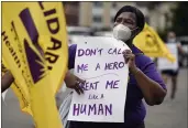  ?? JESSICA HILL — THE ASSOCIATED PRESS FILE ?? Clarissa Johnson of Hartford marches with long-term care members of the New England Health Care Employees Union, during a rally to demand new laws to protect longterm caregivers and consumers at the State Capitol in Hartford, Conn.