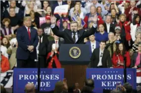  ?? KEITH SRAKOCIC — THE ASSOCIATED PRESS ?? Republican Rick Saccone, right, acknowledg­es the crowd during a campaign rally with President Donald Trump, Saturday in Moon Township, Pa.