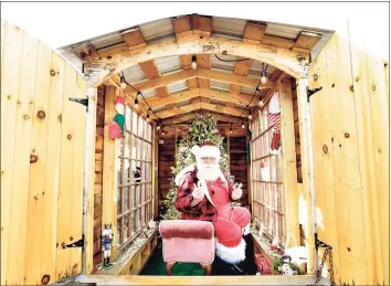  ??  ?? Rick George, of Milford, has been Santa Claus for over 30 years and will interact with children differentl­y this year during the pandemic by putting himself "under glass" in a specially built trailer that will socially distance him and still be able to interact with children and give them candy canes through a chute on the side of the trailer.