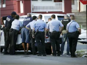  ?? AP PHOTO/MATT ROURKE ?? Philadelph­ia police stage as they respond to an active shooting situation, Wednesday, Aug. 14, in the Nicetown neighborho­od of Philadelph­ia.