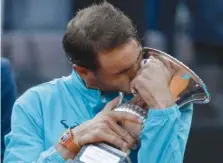  ?? AP PHOTO/GREGORIO BORGIA ?? Rafael Nadal kisses his trophy after winning against Novak Djokovic in Sunday’s final match at the Italian Open tennis tournament in Rome.