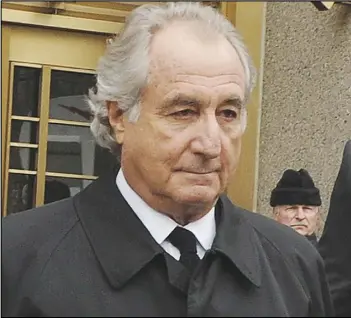  ?? ASSOCIATED PRESS FILES ?? Bernard Madoff exits Manhattan federal court in New York in 2009. Madoff, the financier who pleaded guilty to orchestrat­ing the largest Ponzi scheme in history, died early Wednesday in a federal prison. He was 82.