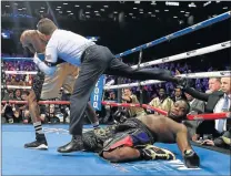  ??  ?? DOWN AND OUT: An overweight Bermane Stiverne on the canvas, above, after Deontay Wilder sealed victory with a devastatin­g four-punch combinatio­n