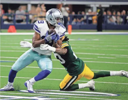  ?? MICHAEL AINSWORTH, AP ?? Dallas Cowboys wide receiver Amari Cooper (19) catches a pass in front of Green Bay Packers' Kevin King, rear, in the second half of an NFL football game in Arlington, Texas, Sunday, Oct. 6, 2019.