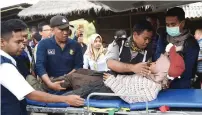  ?? Reuters ?? Rescue team members give treatment to a climber after walking down from Rinjani Mountain in Lombok Timur. —