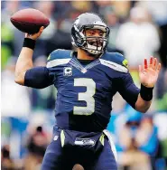  ?? CHRISTIAN PETERSEN/Getty Images) ?? Seattle Seahawks quarterbac­k Russell Wilson shrugged off four intercepti­ons Sunday and led his team to an OT victory
over the Green Bay Packers in the NFC championsh­ip.
