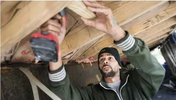  ??  ?? Joshua Voaklander works to repair his home damaged by flooding Florence on Feb. 1, in Conway, S.C. AP PHOTO/SEAN RAYFORD