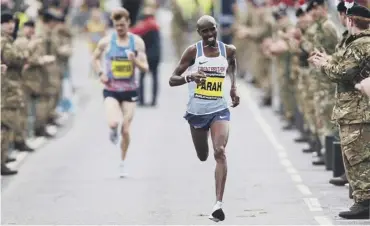  ??  ?? 0 Mo Farah races for the line ahead of New Zealander Jake Robertson to win the Great North Run.