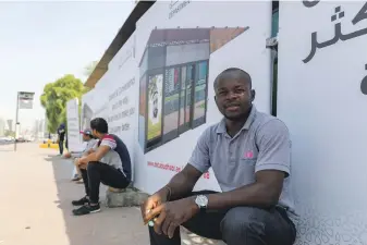  ?? Chris Whiteoak / The National ?? Bus traveller and former taxi driver Brain Ekole welcomes the plans for more air-conditione­d shelters and says more footbridge­s would improve public safety