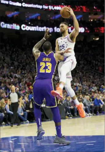  ?? CHRIS SZAGOLA — THE ASSOCIATED PRESS ?? 76ers’ Ben Simmons, right, goes up for the shot as he is fouled boy Los Angeles Lakers’ LeBron James, left, during the second half. The 76ers won 143-120.