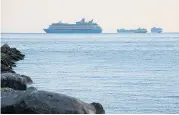  ?? REUTERS ?? A group of cruise ships are seen anchored in Manila Bay earlier this month as crew members undergo quarantine amid the coronaviru­s outbreak.