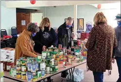  ?? COURTESY OF JUDY TRUJILLO ?? Members of the Tehachapi Rotary Club gathered Thursday to prepare food boxes to be delivered to local seniors for the holidays.