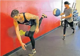  ??  ?? Jordan Holloway (left) and Braxton Garrett work out as part of their rehab program at Cressey Sports Performanc­e.
