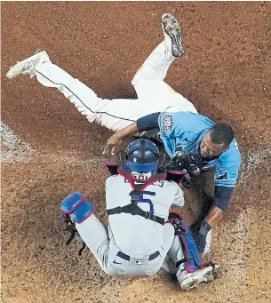  ?? DAVID J. PHILLIP THE ASSOCIATED PRESS ?? The 2020 World Series has included a little bit of everything, including an attempted steal of home by Tampa Bay’s Manuel Margot in Game 5. He was tagged out by Austin Barnes.