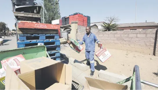  ?? Pictures: Nigel Sibanda ?? ADDING TO THE LOAD. Mlungisi Mavimbela with cardboard boxes and a can to add to his load of recylables.