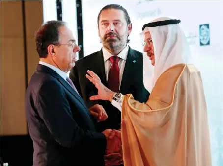  ?? Reuters ?? Lebanese Prime Minister Saad Hariri and his adviser Nadim Al-Mulla with UAE Economy Minister Sultan bin Saeed Al-Mansouri in Abu Dhabi.
