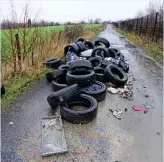  ??  ?? Hazard: Dumped tyres block a lane in Barnsley, South Yorkshire