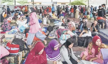  ??  ?? Survivors rest at a relief centre in Kalianda in Lampung province after they were evacuated from Sebesi island following the tsunami that was caused by activity at a volcano known as the ‘child’ of Krakatoa.