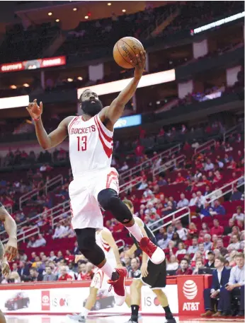  ?? (AP FOTO) ?? ANTI-GRAVITY. Houston Rockets guard James Harden goes up for a shot against the Brooklyn Nets, hoisting his team by 36 points to a 122-118 win.