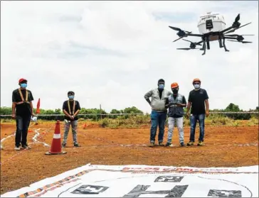  ?? AFP ?? Technician­s fly a drone belonging to the Throttle Aerospace Systems (TAS) which flies Beyond Visual Line of Sight (BVLOS) to deliver life saving medical supplies.