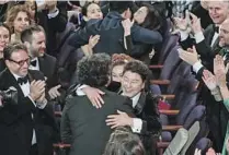  ?? Robert Gauthier Los Angeles Times ?? AWARDS moments: Will Smith, top, gives his lead actor Oscars acceptance speech not long after “the slap.” Dawn Hudson and David Oyelowo at a 2019 AMPAS ceremony. Bong Joon Ho’s “Parasite” wins best picture in 2020.