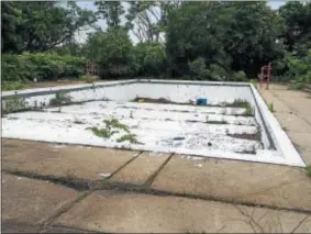  ?? L.A. PARKER — THE TRENTONIAN ?? A closed city pool at Hetzel field shows weeds, discarded garbage and human excrement.