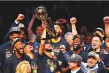  ?? AFP ?? The Golden State Warriors celebrate with the Larry O’Brien Trophy after defeating the Cleveland Cavaliers in Game Four of the NBA Finals at Quicken Loans Arena.