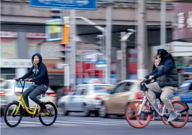  ?? AFP ?? Industry evangelist­s say the new approach to bike-sharing can help solve the ‘first-mile/last-mile’ problem that has long plagued urban planners: how to move commuters between their homes and public transit. —