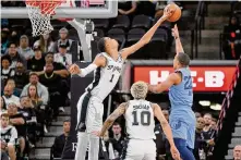  ?? Darren Abate/associated Press ?? San Antonio’s Victor Wembanyama blocks a shot by Desmond Bane of the Grizzlies. The Spurs’ rookie registered eight blocks on Saturday, along with 19 points and 13 rebounds in the loss to Memphis.