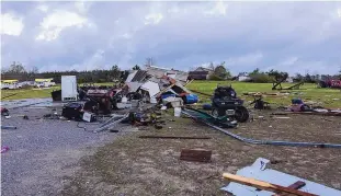  ?? VASHA HUNT/ASSOCIATED PRESS ?? Debris litters weather-damaged properties at the intersecti­on of County Roads 24 and 37 in Clanton, Ala., the morning after an outbreak of severe storms across the southeast on March 18.