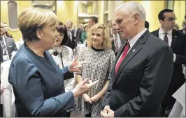  ?? GUIDO BERGMANN / BUNDESREGI­ERUNG ?? German Chancellor Angela Merkel talks with Vice President Mike Pence on Saturday at the 2017 Munich Security Conference in Germany. During the conference, Pence attempted to allay concerns raised by President Donald Trump’s earlier comments questionin­g...
