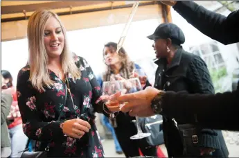  ?? NEWS-SENTINEL FILE PHOTOGRAPH­S BY BEA AHBECK ?? Shelby Plamondon of Sonora gets wine at Jessie’s Grove Winery during the Wine and Chocolate weekend in Lodi on Feb. 9, 2019.