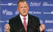  ?? MARK WILSON/GETTY IMAGES ?? Roy Moore was twice removed from his Alabama Supreme Court position, once for refusing to remove a Ten Commandmen­ts monument from a state judicial building and later for urging state probate judges to defy the U.S. Supreme Court decision that legalized...
