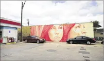  ??  ?? Australian artist Rone began painting this mural on the wall of Cycleast in February for SXSW. Owner Russell Pickavance gave his approval to re-create the lotería mural. SWSW will help pay for the repainting.