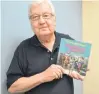  ?? SALLY COLE/ THE GUARDIAN ?? Garth Proude holds a copy of “Rememberin­g Singalong Jubilee”. Proud, who joined “Singalong Jubilee” in 1965 as band leader/bass player, is “honoured” that another generation is discoverin­g “Singalong Jubilee”. He plans to see the show.