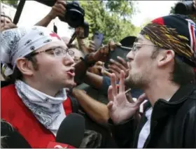  ?? AP PHOTO/MICHAEL DWYER ?? A counterpro­tester, left, confronts a professed supporter of President Donald Trump at a “Free Speech” rally by conservati­ve activists on Boston Common, Saturday, Aug. 19, 2017, in Boston. Thousands of leftist counterpro­testers marched through downtown...