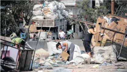  ?? | ?? NECESSITY PEOPLE collect cardboard and rubbish to sell it in Buenos Aires, yesterday. Argentina’s President Macri acknowledg­ed that the new poverty index would reflect the economic crisis in the country, and called for ‘consensus’ to face it. Argentina has been in crisis since last year, which ended with 32.5% of the population in poverty.